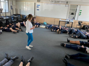 Larissa Halls teaching meditation at a school