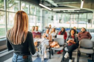 A meditation teacher earning an income teaching mindfulness to a group